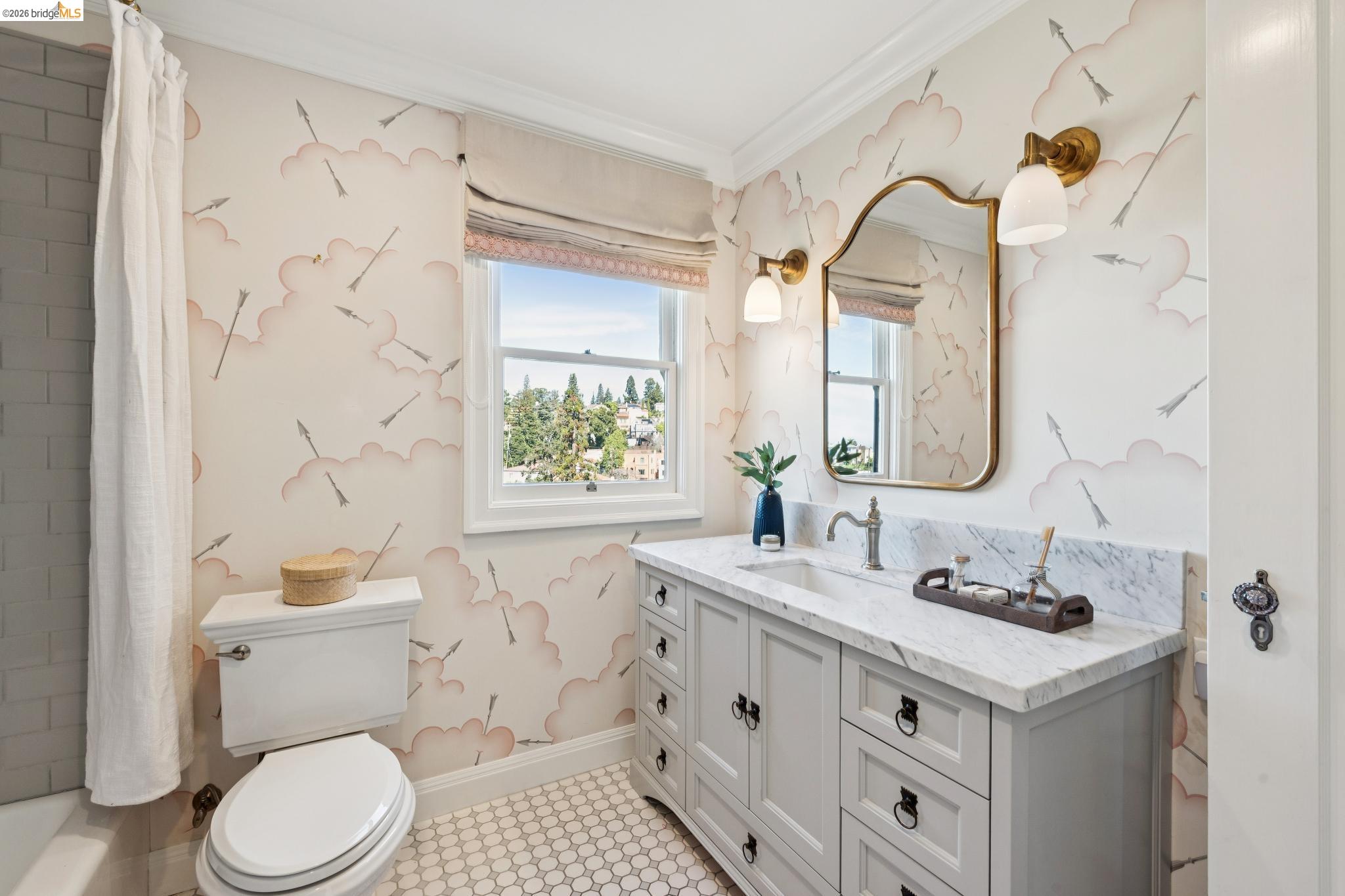 906 Paramount Road Oakland, CA 94610 - Photo 30 of 60 a bathroom with a sink a toilet and a mirror