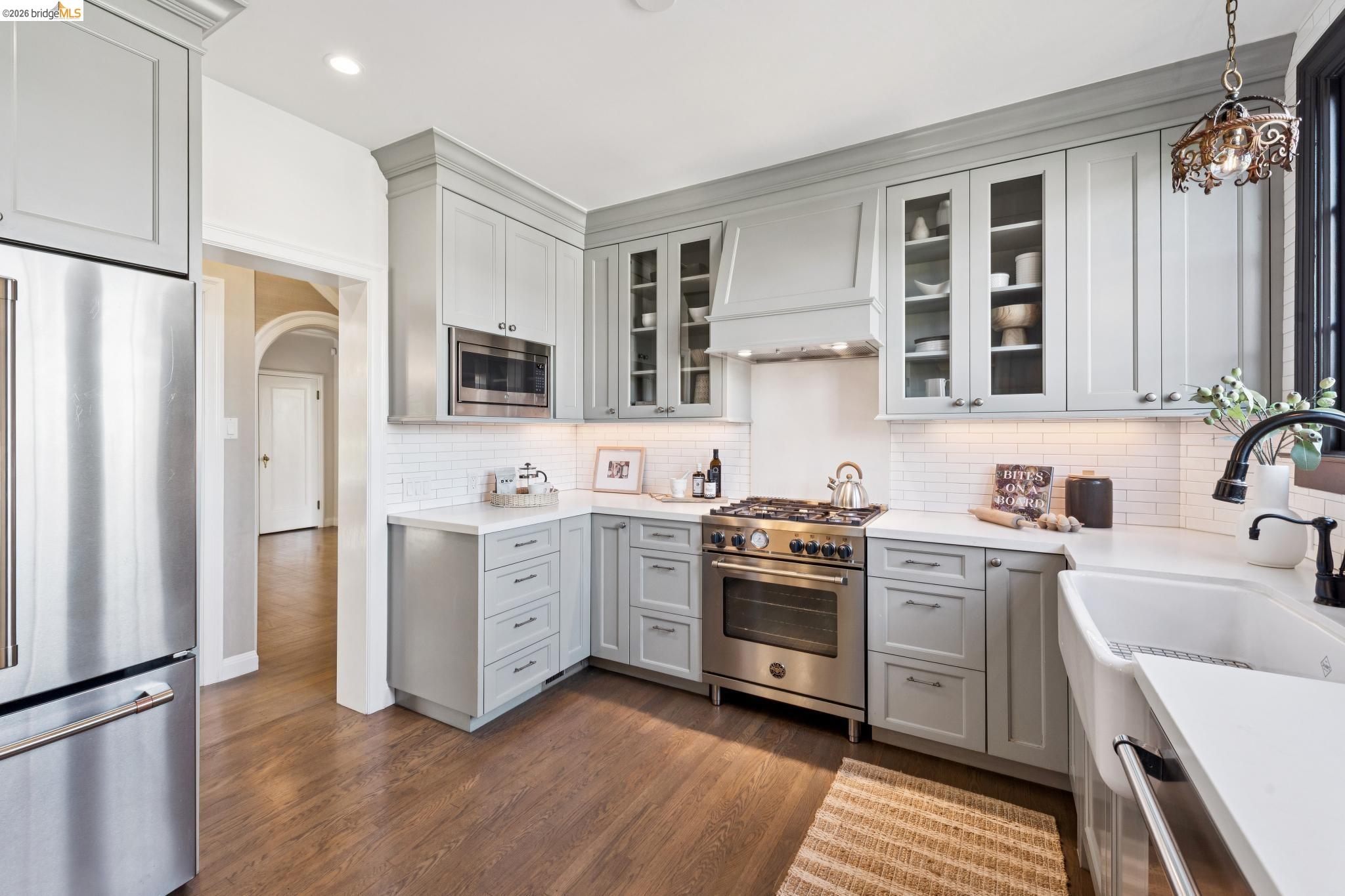 906 Paramount Road Oakland, CA 94610 - Photo 48 of 60 a kitchen with white cabinets stainless steel appliances and sink