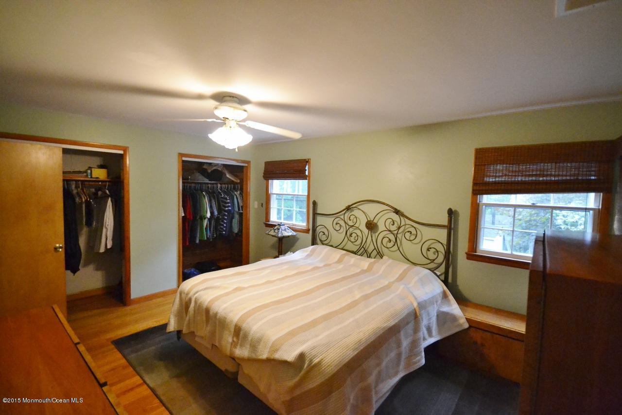 4 Spring Lane Warren, NJ 07059 - Photo 12 of 22 a bedroom with a large bed and a chandelier