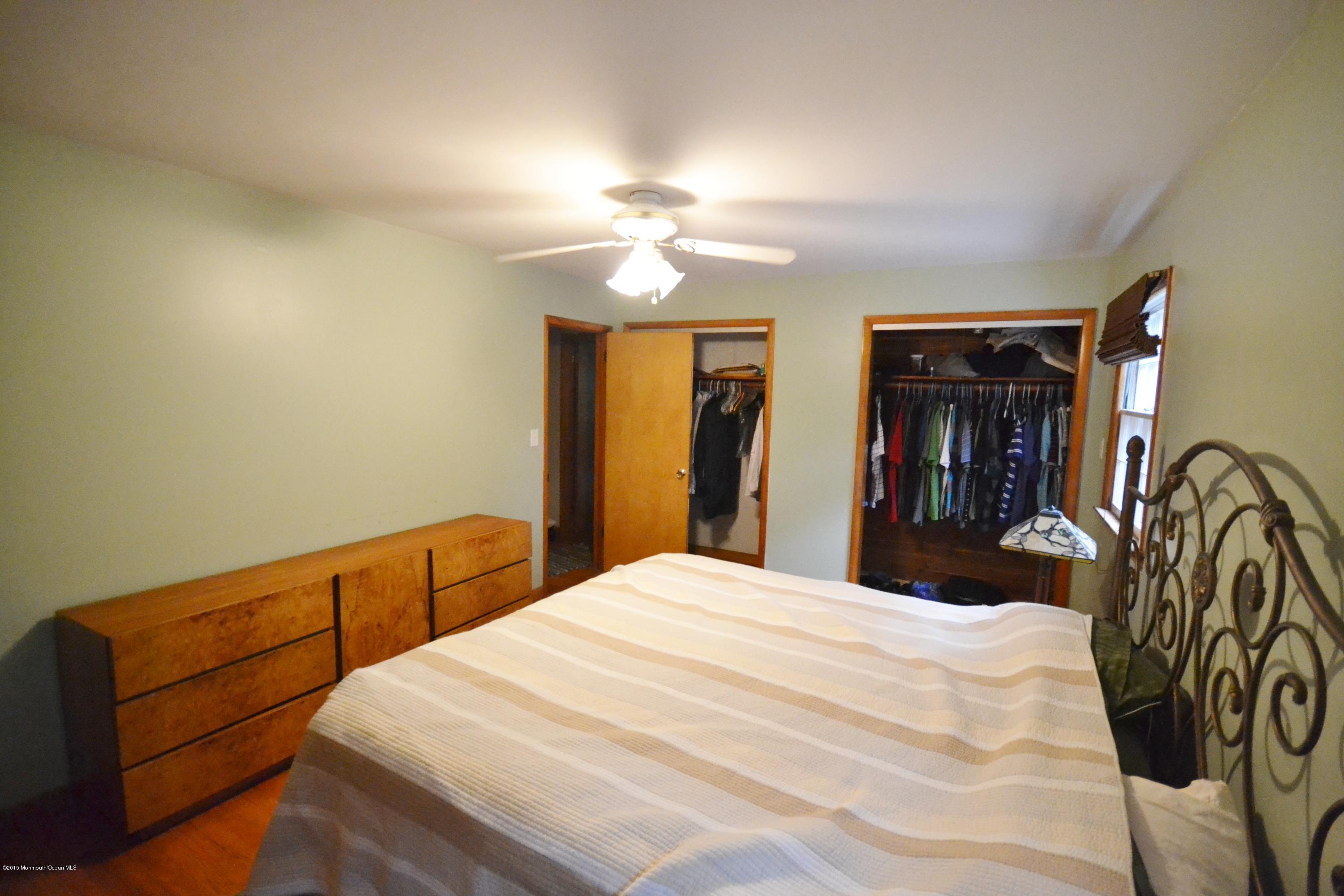 4 Spring Lane Warren, NJ 07059 - Photo 13 of 22 a bedroom with a bed and a chandelier