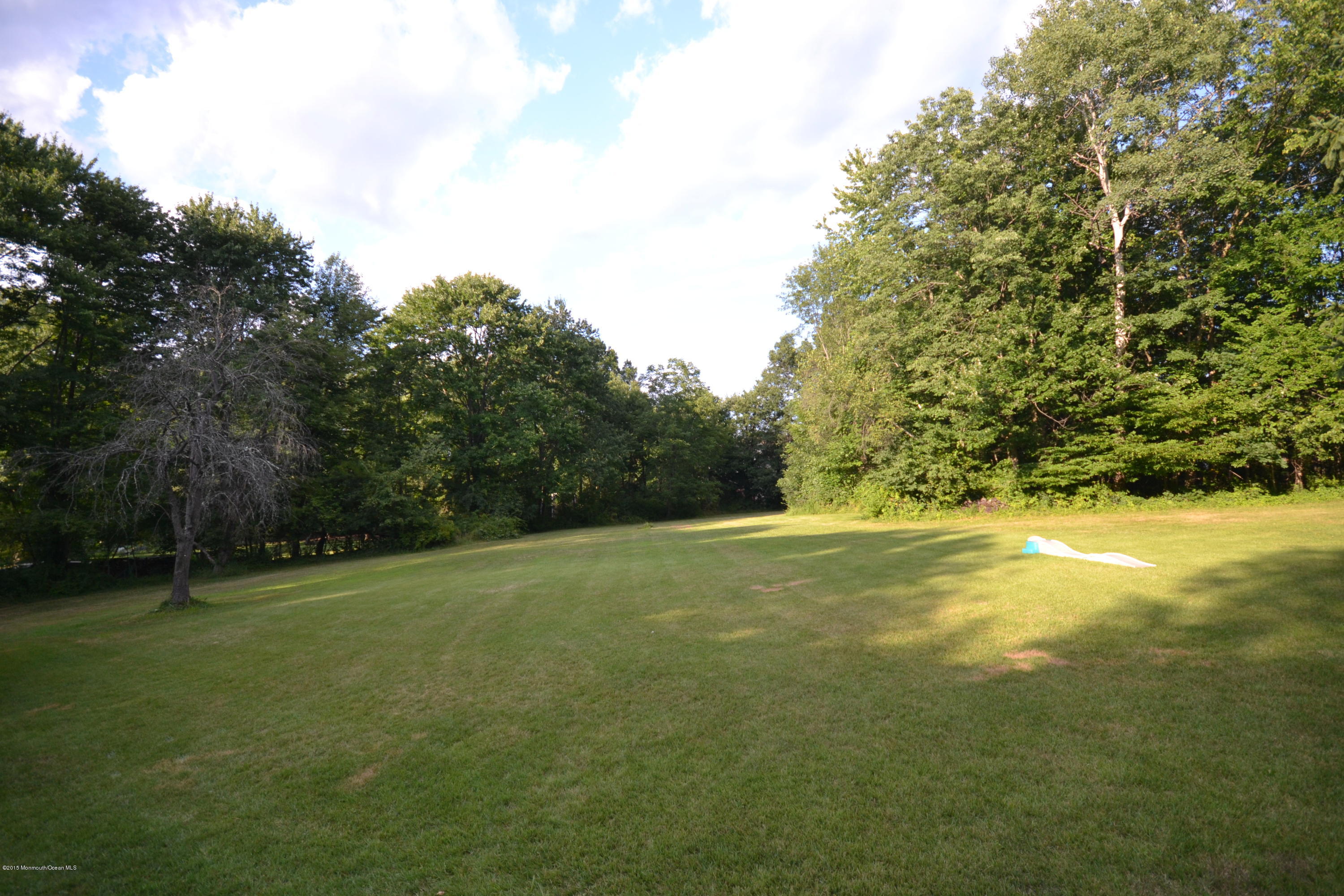 4 Spring Lane Warren, NJ 07059 - Photo 2 of 22 a view of a field with trees in the background