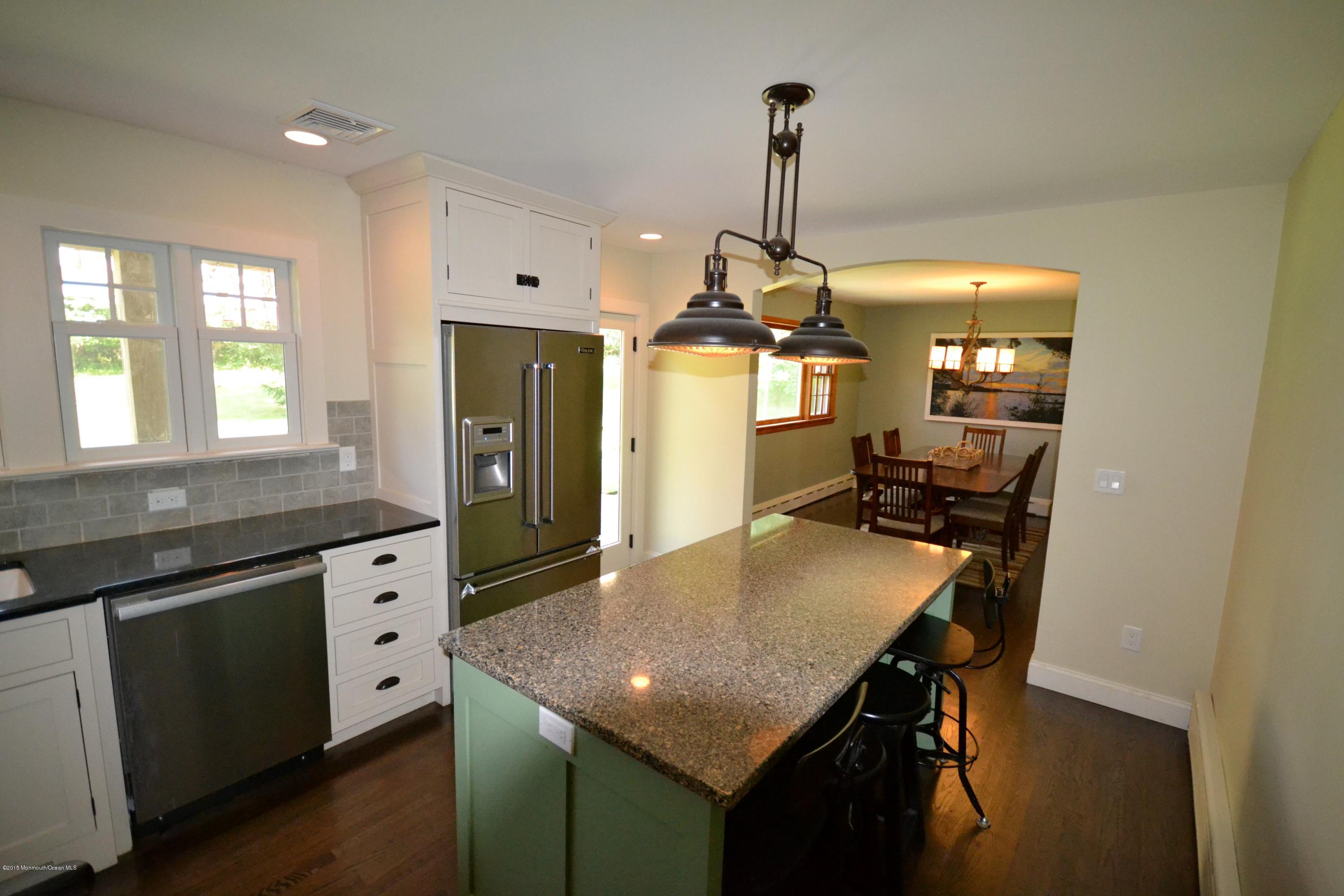 4 Spring Lane Warren, NJ 07059 - Photo 3 of 22 a kitchen with a table chairs and wooden floor