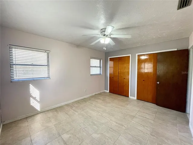 a view of an empty room with windows