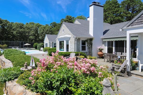 155 Ice Valley Road Osterville, MA 02655 - Photo 3 of 19 a front view of a house with a garden