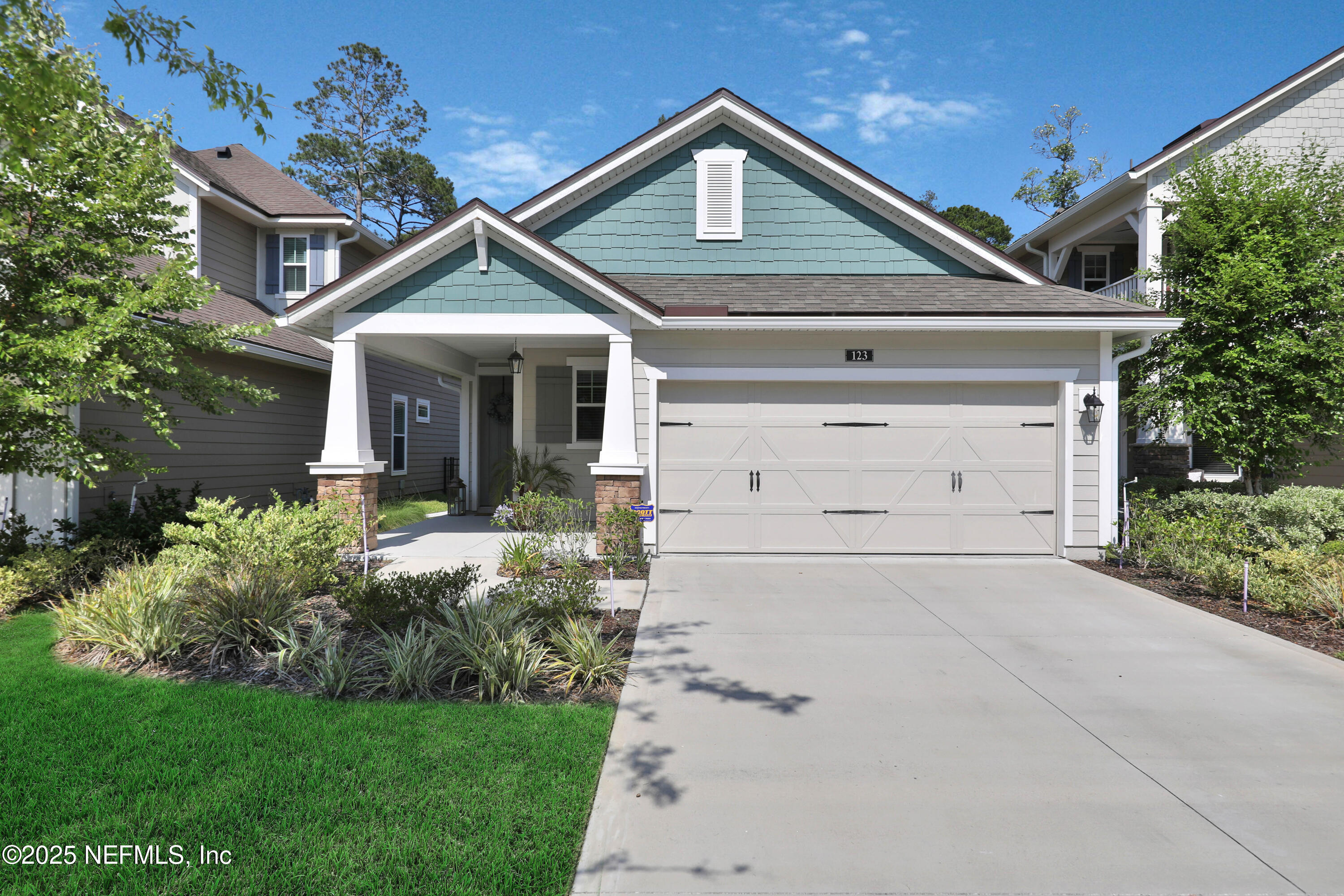 123 Bison Trail Ponte Vedra, FL 32081 - Photo 1 of 23 a front view of a house with a yard and garage
