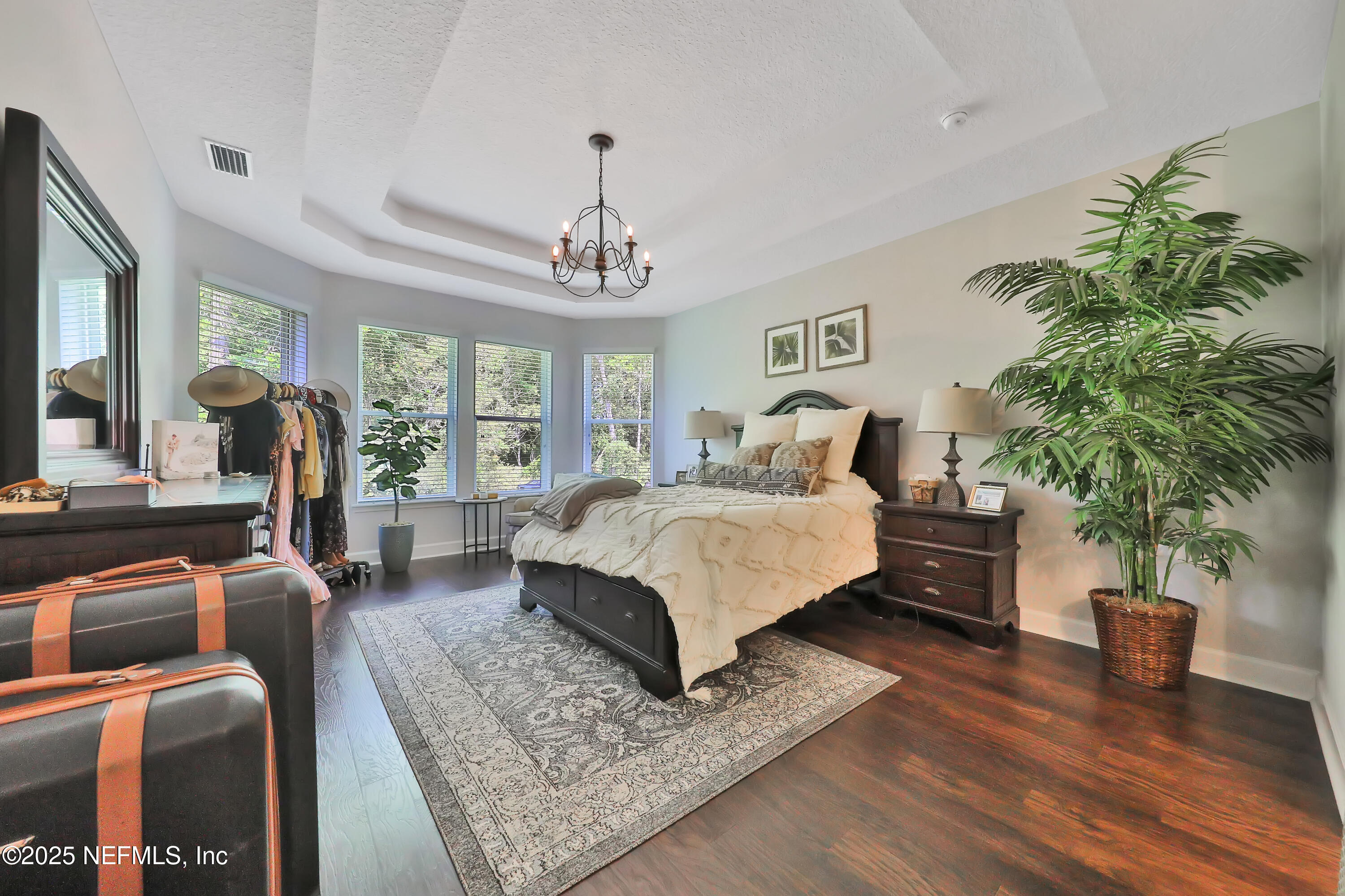 123 Bison Trail Ponte Vedra, FL 32081 - Photo 14 of 23 a bedroom with a large bed and a potted plant