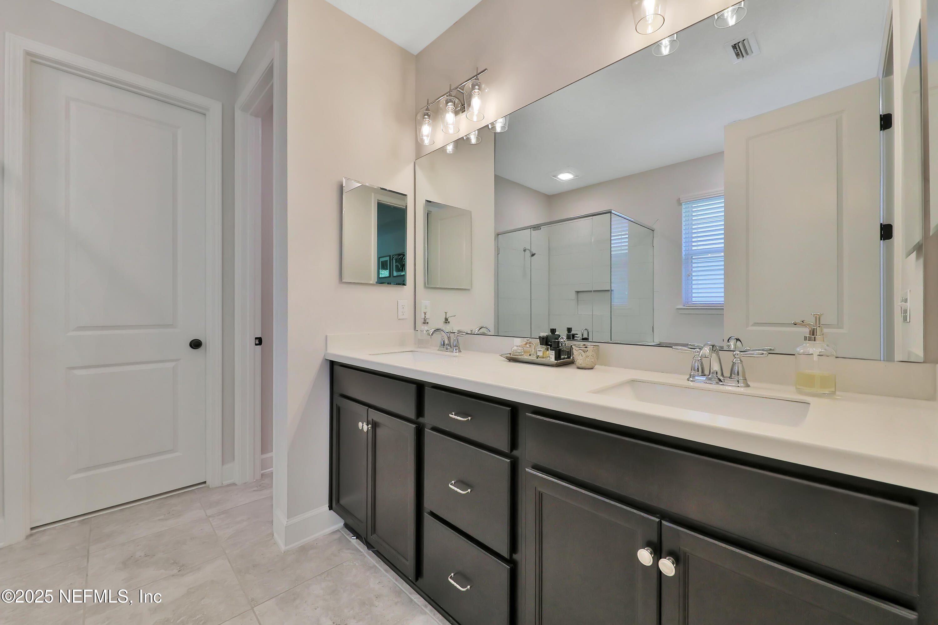 123 Bison Trail Ponte Vedra, FL 32081 - Photo 17 of 23 a bathroom with a double vanity sink and a mirror