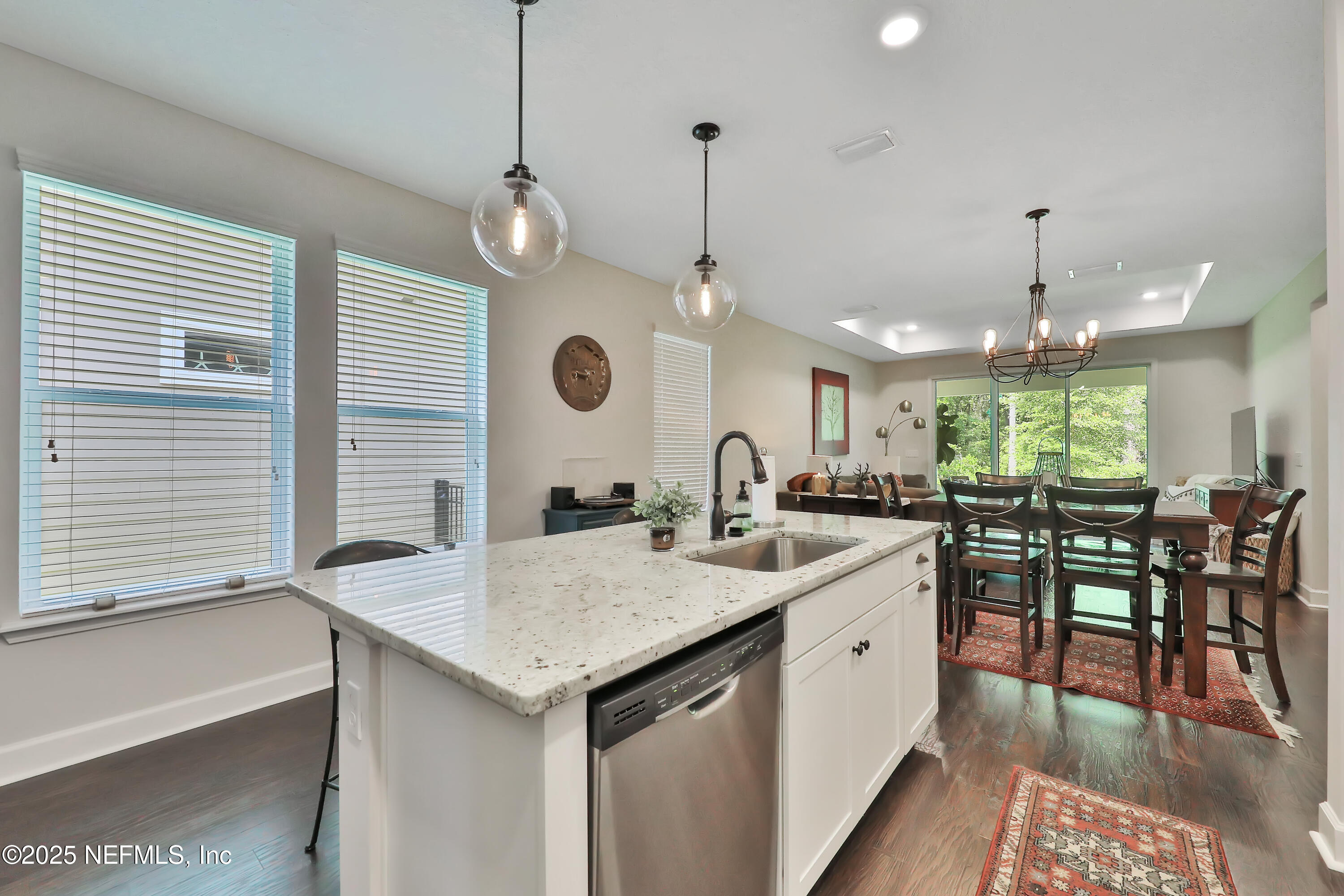123 Bison Trail Ponte Vedra, FL 32081 - Photo 3 of 23 a kitchen with a table chairs and white cabinets