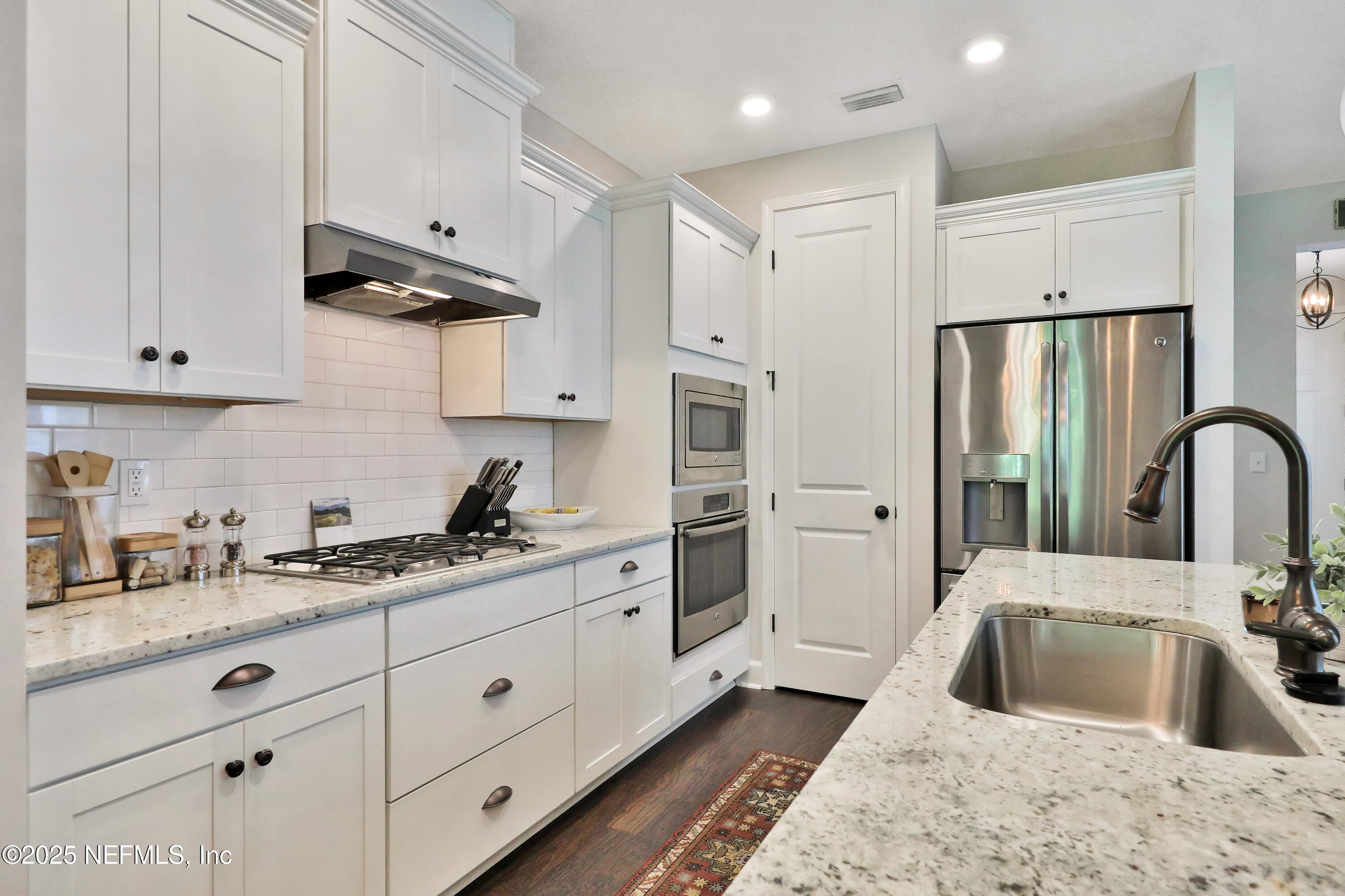 123 Bison Trail Ponte Vedra, FL 32081 - Photo 9 of 23 a kitchen with stainless steel appliances granite countertop a sink a refrigerator and white cabinets