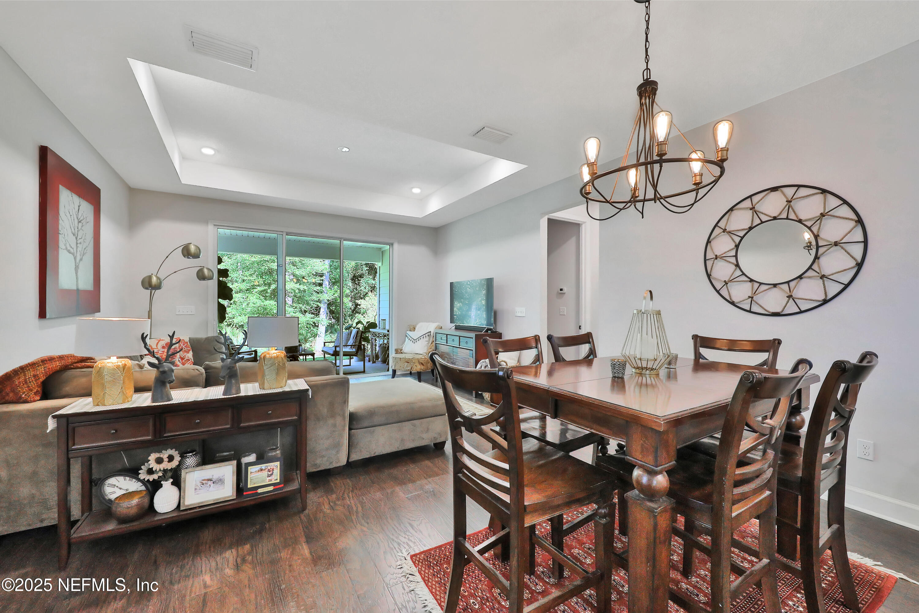 123 Bison Trail Ponte Vedra, FL 32081 - Photo 10 of 23 a view of a dining room and livingroom with furniture wooden floor a chandelier