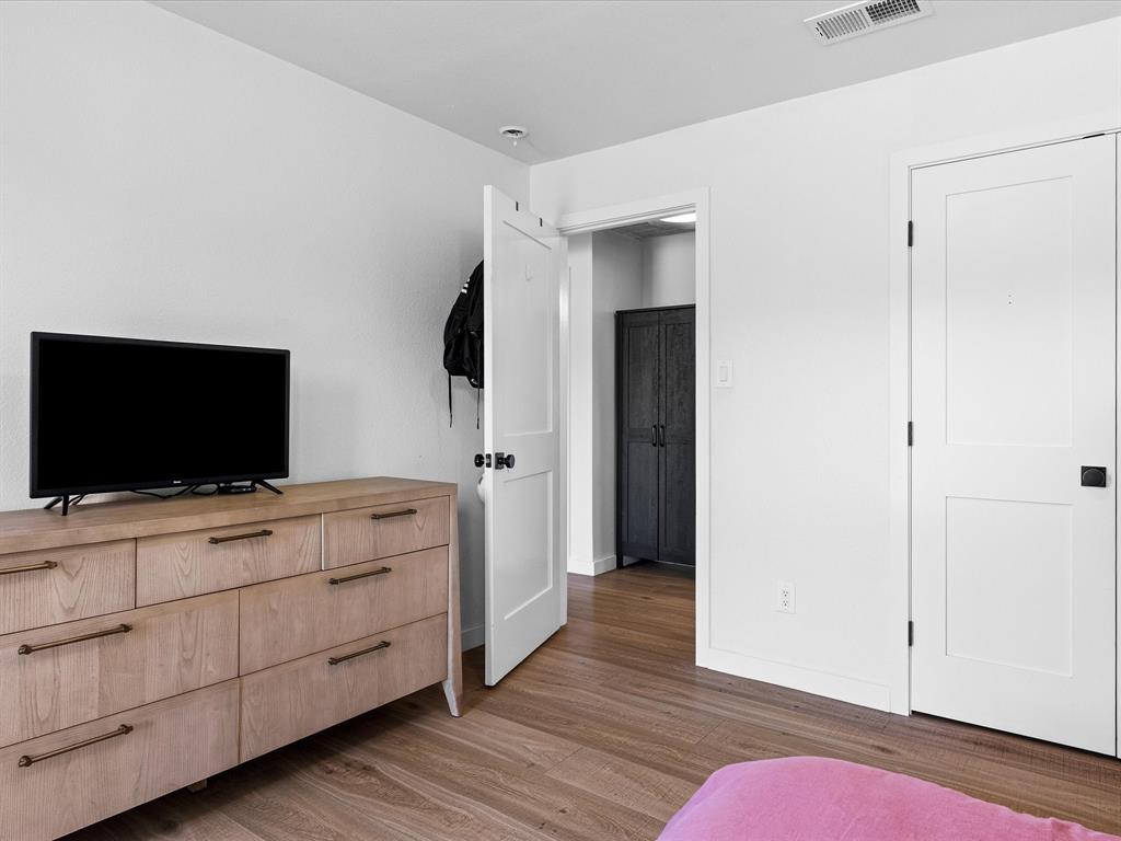 946 Burke Road Gunter, TX 75058 - Photo 21 of 38 a room with a bed and a television