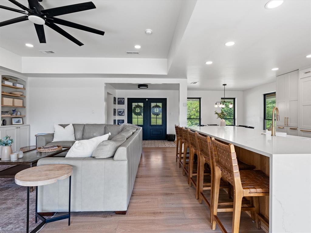 946 Burke Road Gunter, TX 75058 - Photo 8 of 38 a large living room with stainless steel appliances furniture large window and wooden floor