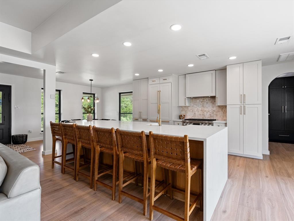 946 Burke Road Gunter, TX 75058 - Photo 9 of 38 a kitchen with stainless steel appliances granite countertop a dining table chairs refrigerator and microwave