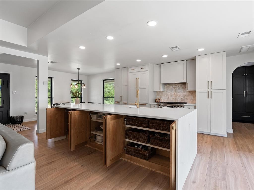 946 Burke Road Gunter, TX 75058 - Photo 10 of 38 a kitchen with stainless steel appliances granite countertop a refrigerator a sink dishwasher a stove and white countertops with wooden floor
