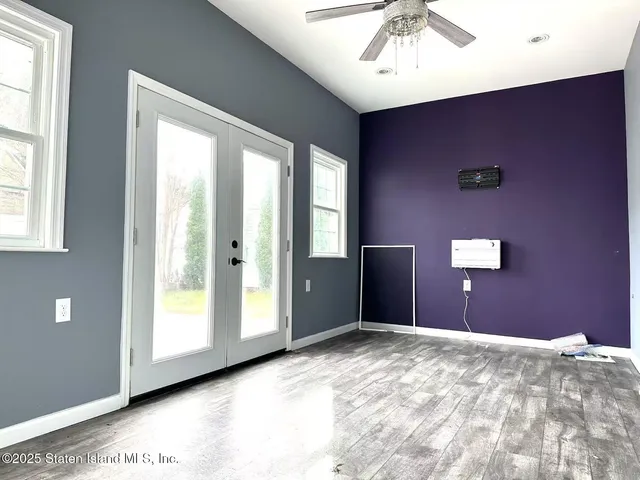 a view of a livingroom with a ceiling fan and window