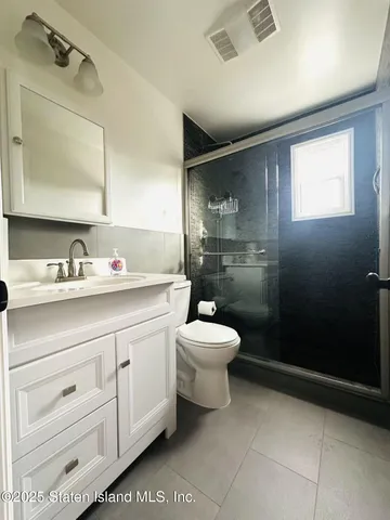 a bathroom with a toilet sink and shower