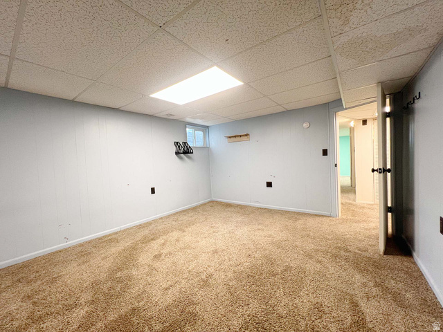 3138 Jean Street Magna, UT 84044 - Photo 23 of 26 Carpeted room featuring light blue panel walls and a drop ceiling with recessed lighting