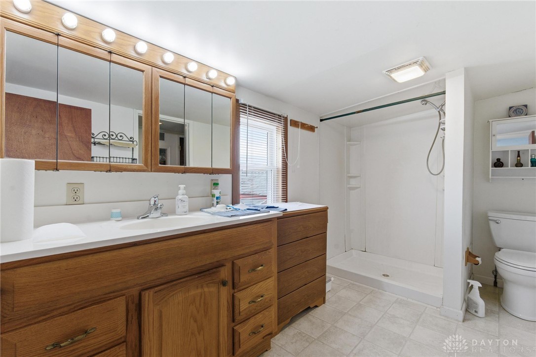 11379 Friend Road Germantown, OH 45327 - Photo 32 of 44 This bright bathroom features a spacious vanity, walk-in shower, and a clean, functional design.