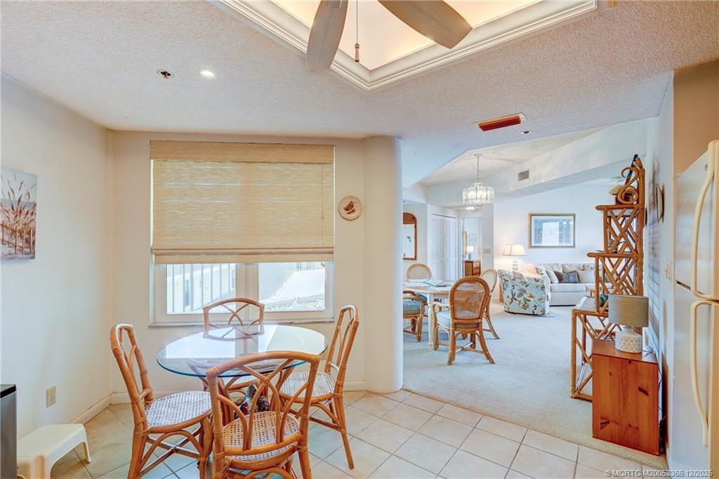221 Northeast Plantation Road, Unit 407 Stuart, FL 34996 - Photo 25 of 42 a view of a dining room with furniture and chandelier