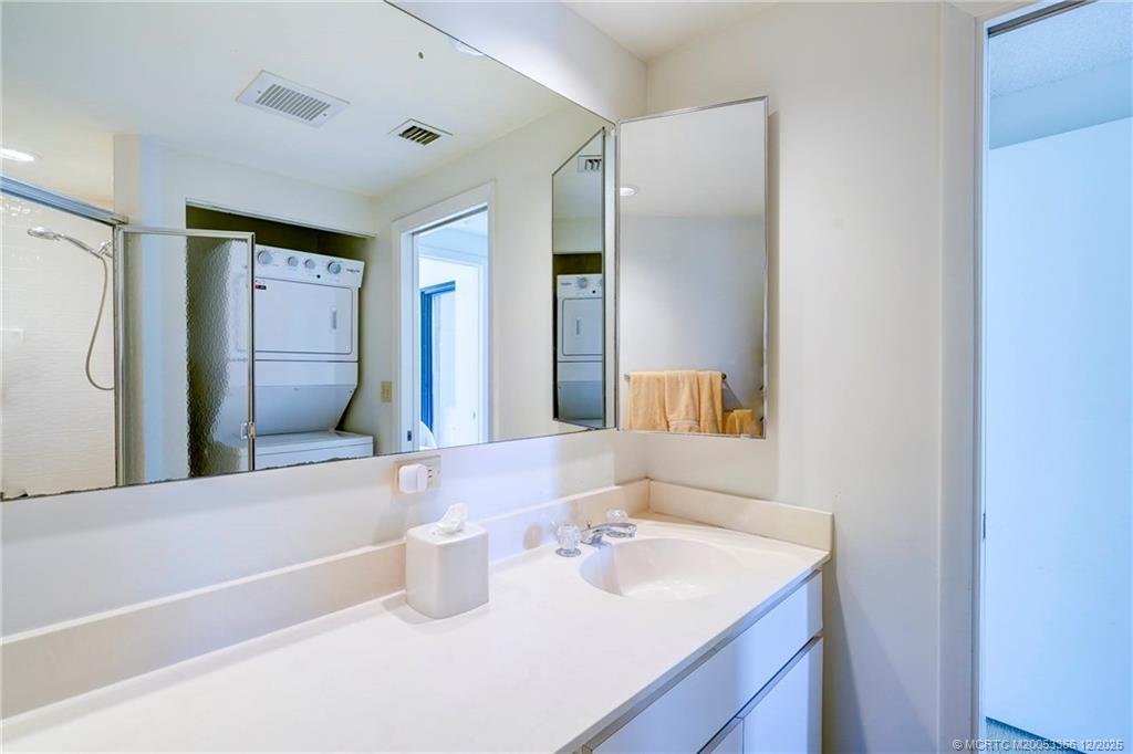 221 Northeast Plantation Road, Unit 407 Stuart, FL 34996 - Photo 32 of 42 a bathroom with a sink and a mirror