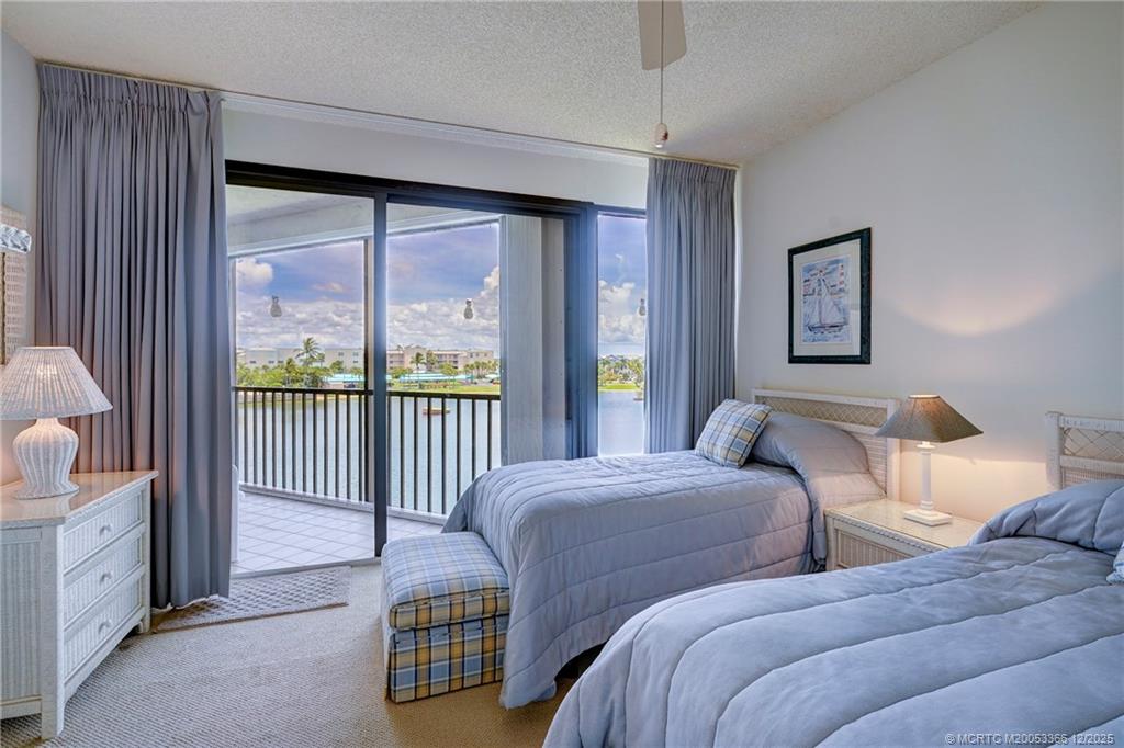 221 Northeast Plantation Road, Unit 407 Stuart, FL 34996 - Photo 33 of 42 a bedroom with two beds and large window