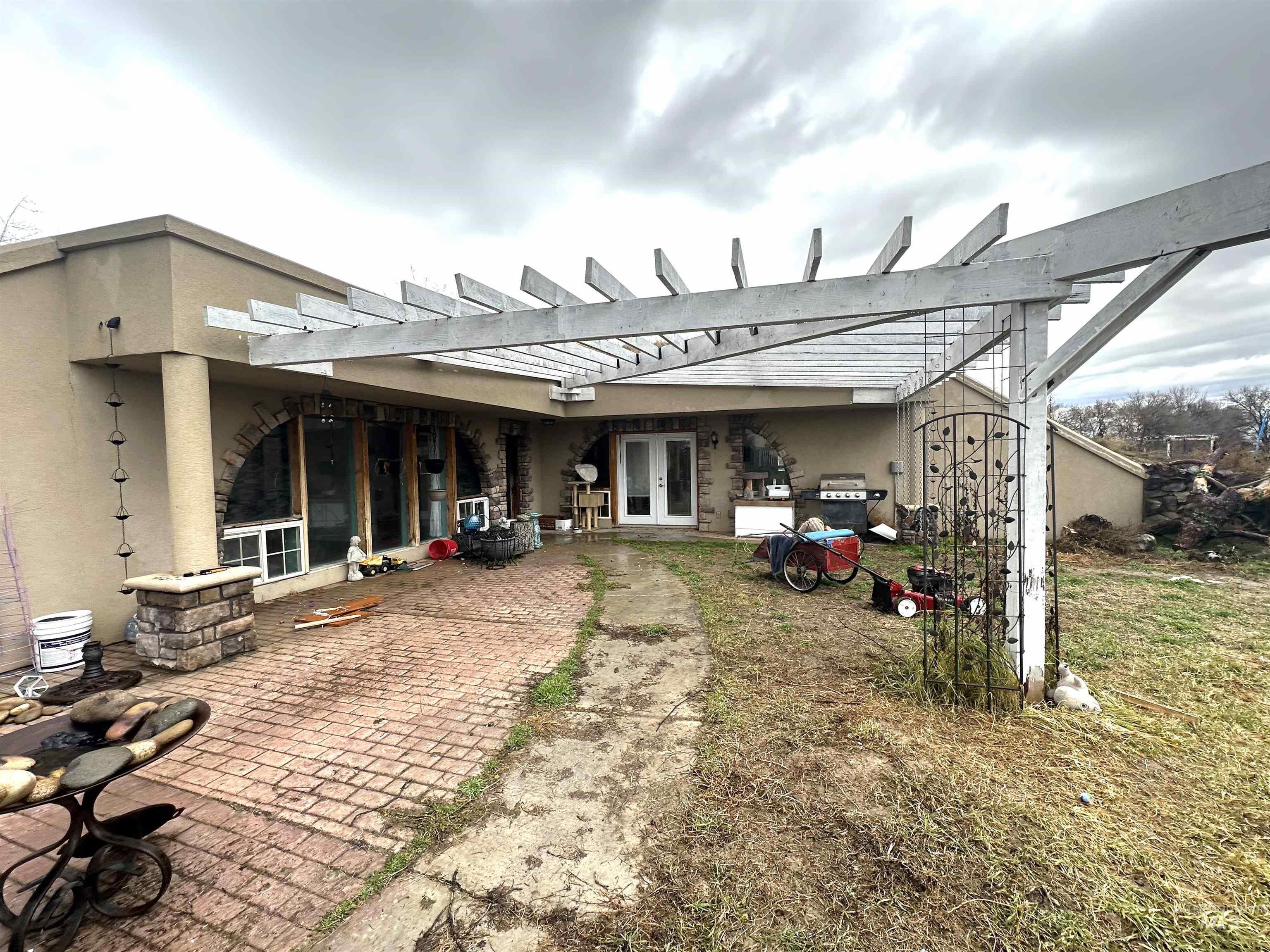 Back of property with a pergola, french doors, a patio, and stucco siding