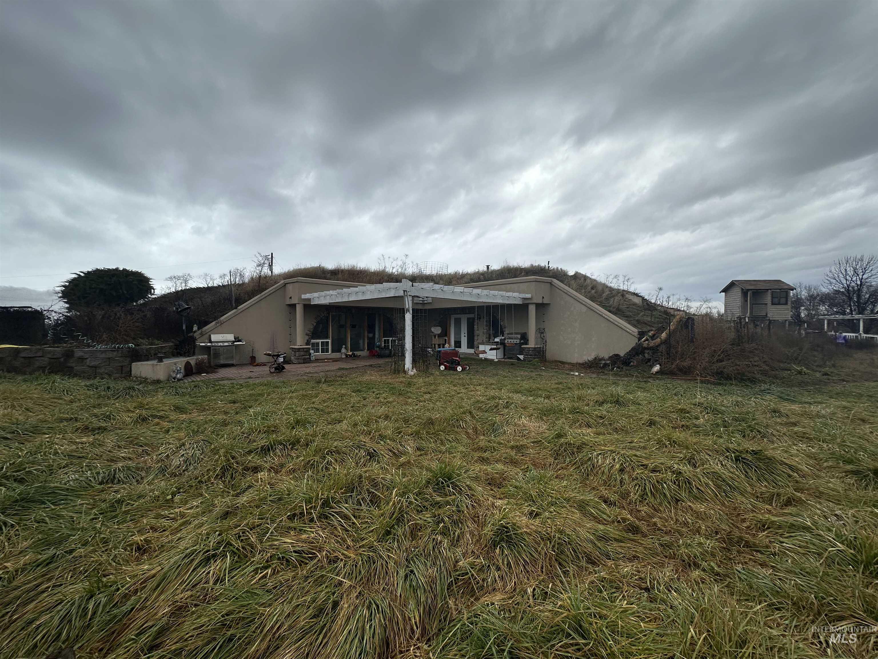 5860 Akron Road New Plymouth, ID 83655 - Photo 30 of 33 Rear view of house with a patio area and a yard