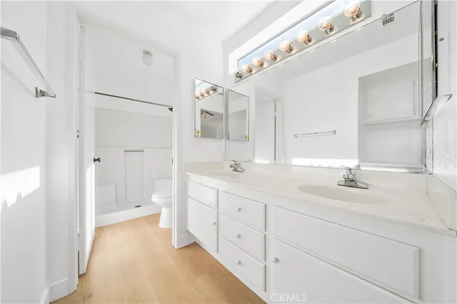 a spacious bathroom with double sink and a mirror