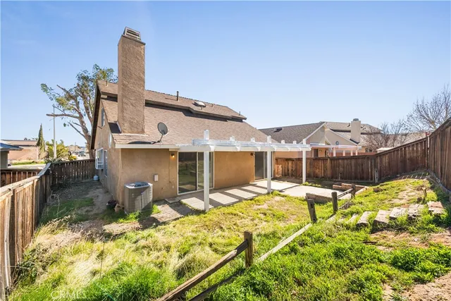 a view of a backyard with a wooden fence