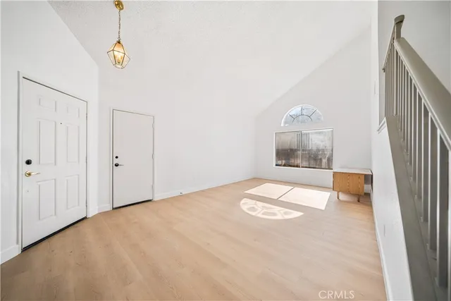 a view of a room with wooden floor and white walls