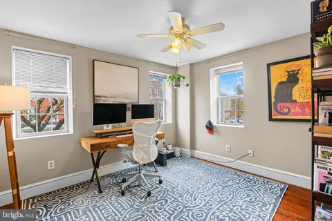 a workspace with wooden floor and a window