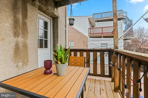 a view of balcony with wooden floor