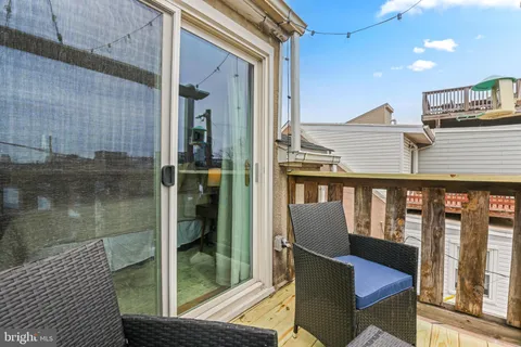 a balcony with table and chairs