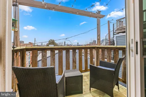 a view of a balcony with wooden floor