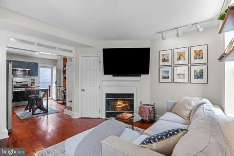 a living room with furniture fireplace and a flat screen tv