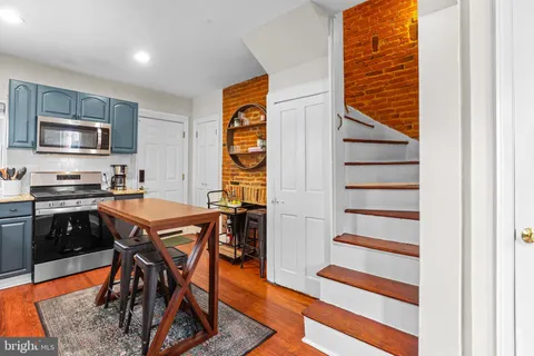 a kitchen with a table and chairs in it