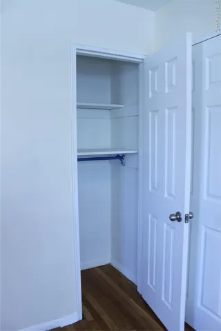 a view of walk in closet with empty racks