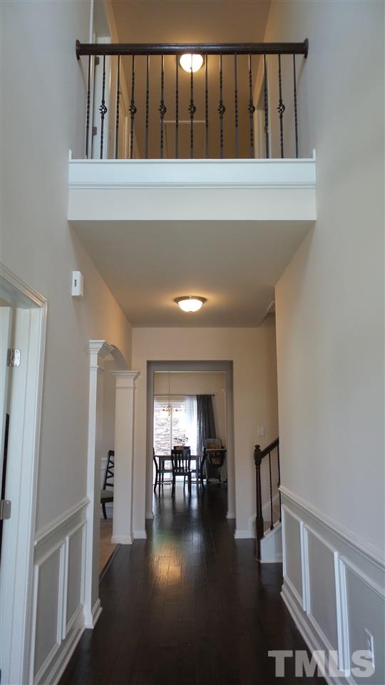 1151 Alsace Drive Apex, NC 27502 - Photo 5 of 25 Stunning view as you enter the home. Wainscoting, wood floors, and 2 story foyer!