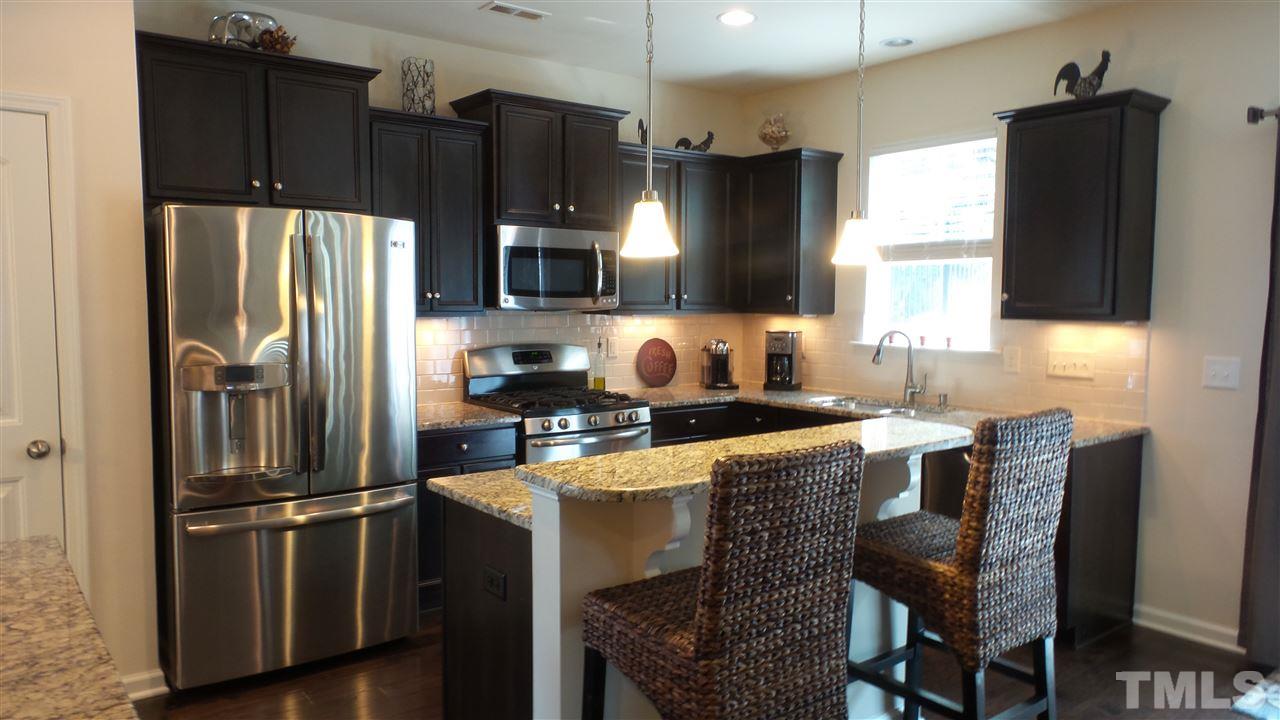 1151 Alsace Drive Apex, NC 27502 - Photo 10 of 25 Beautiful cabinets, stainless steel appliances,granite countertops, wood floors and breakfast bar area!