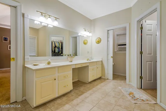 a bathroom with a sink vanity and mirror