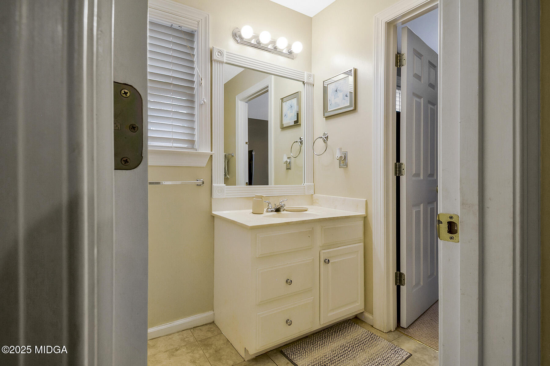 22 Rabon Drive Forsyth, GA 31029 - Photo 29 of 47 a bathroom with a double vanity sink and mirror