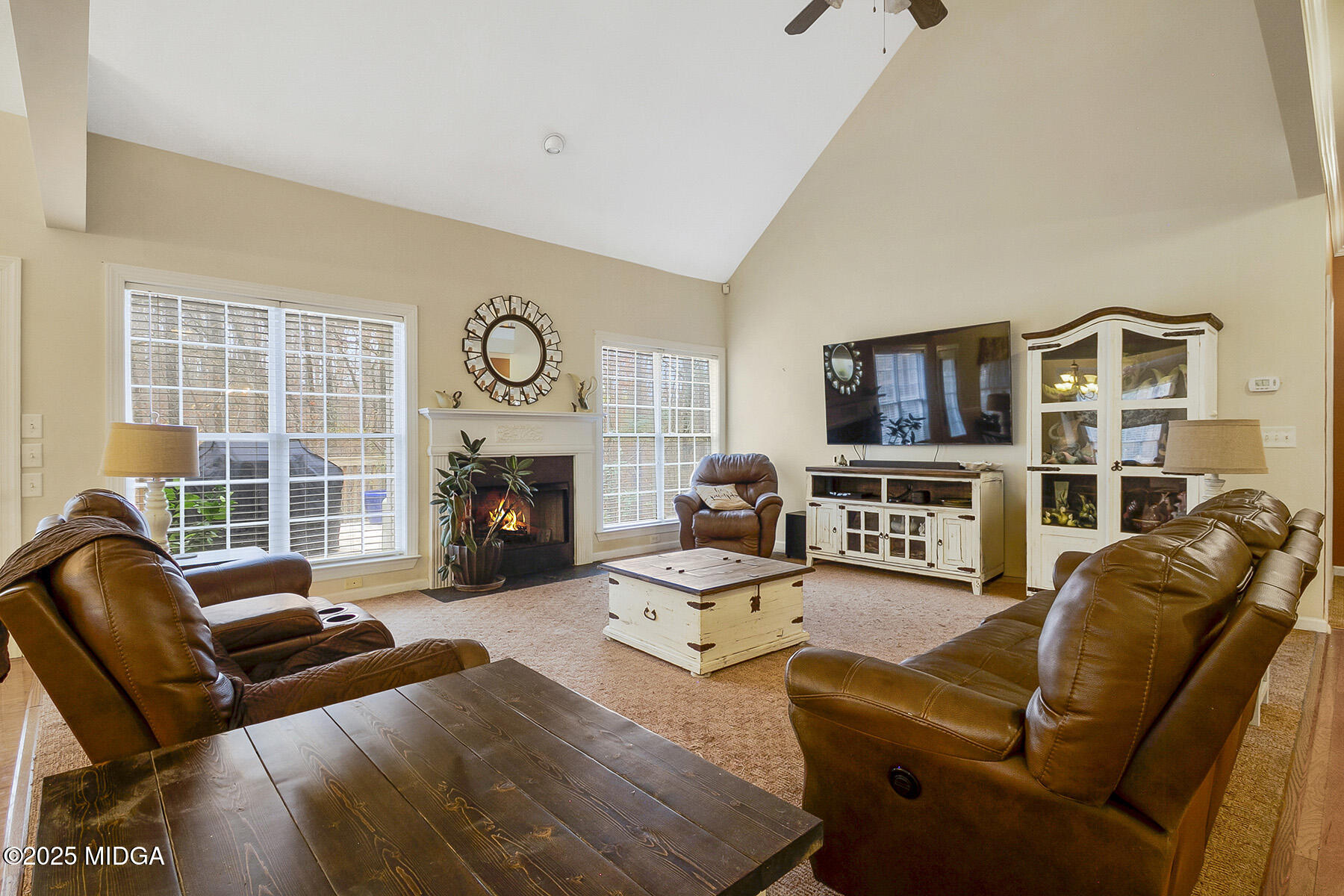 22 Rabon Drive Forsyth, GA 31029 - Photo 7 of 47 a living room with furniture a fireplace and a flat screen tv