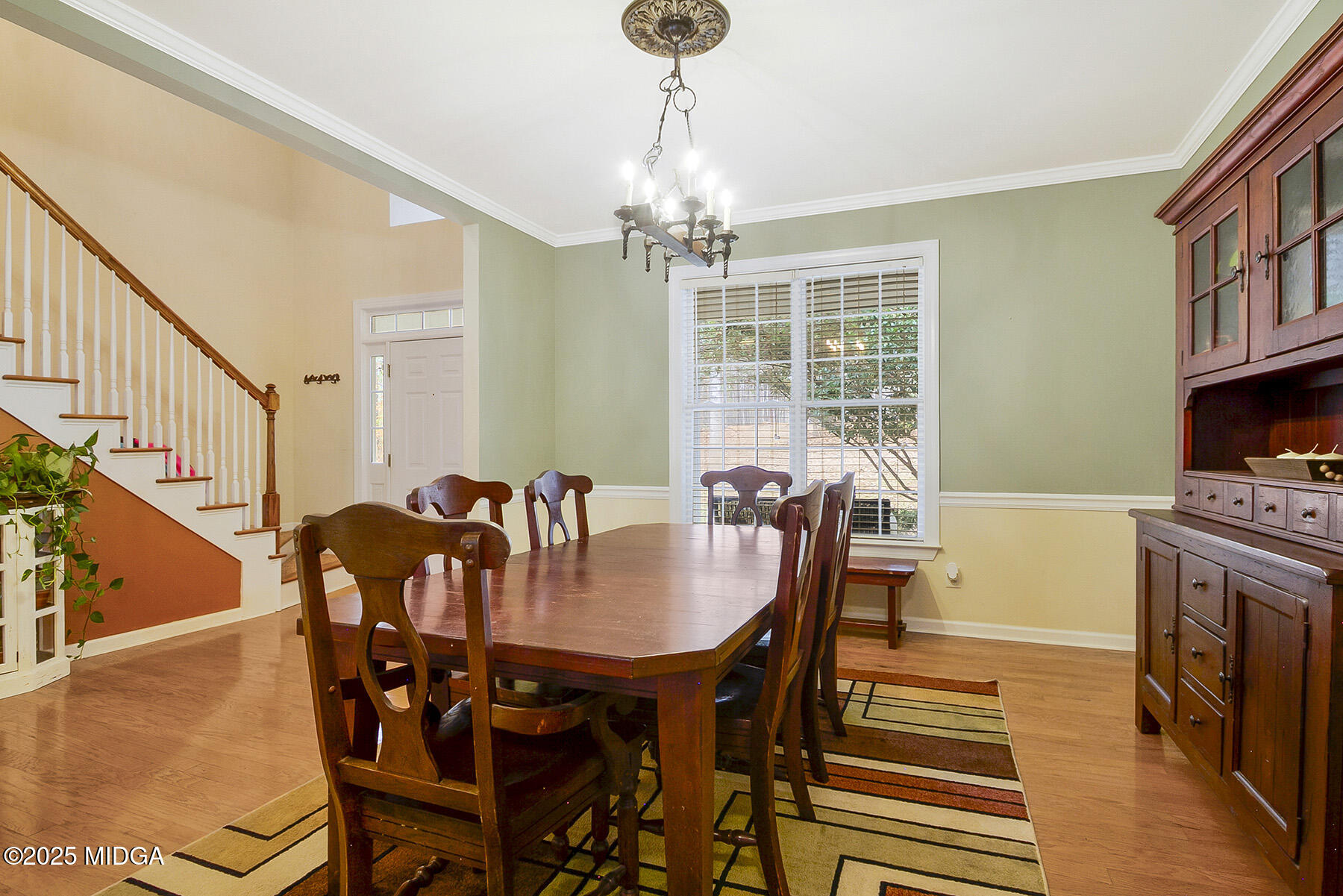 22 Rabon Drive Forsyth, GA 31029 - Photo 9 of 47 a dining room with furniture a chandelier and wooden floor