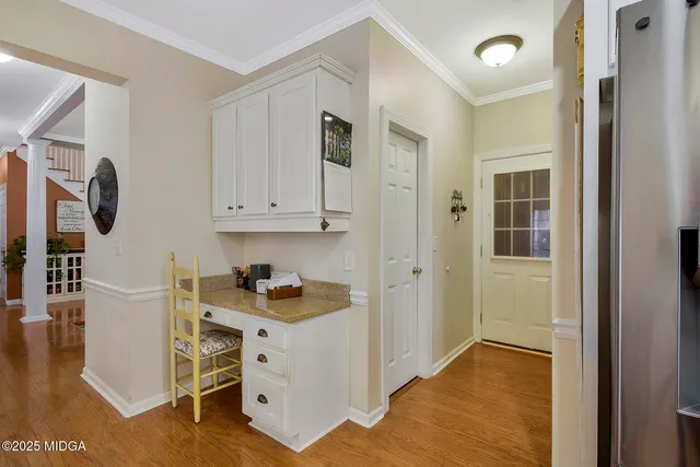a kitchen with granite countertop a sink and a stove next to a white cabinet