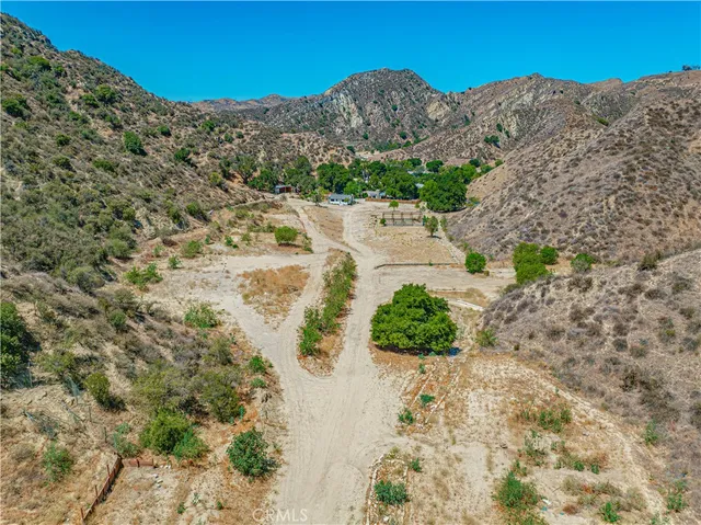 a view of empty room with wooden floor and fireplace
