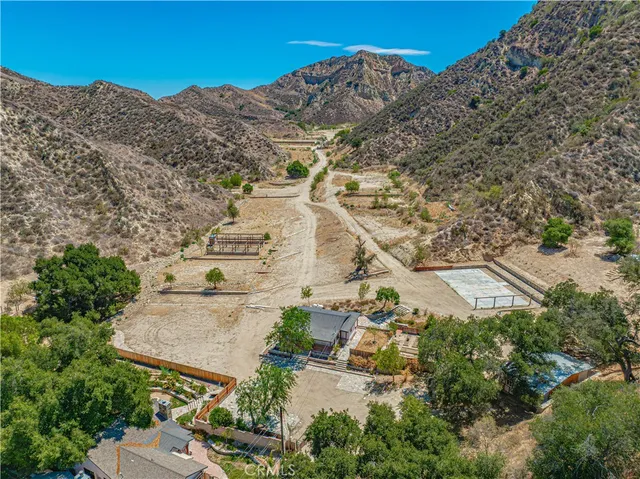 a view of empty room with window and wooden floor