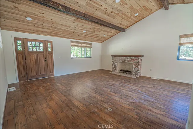 a front view of a house with a tree