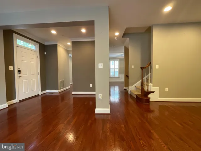 a view of empty room with wooden floor
