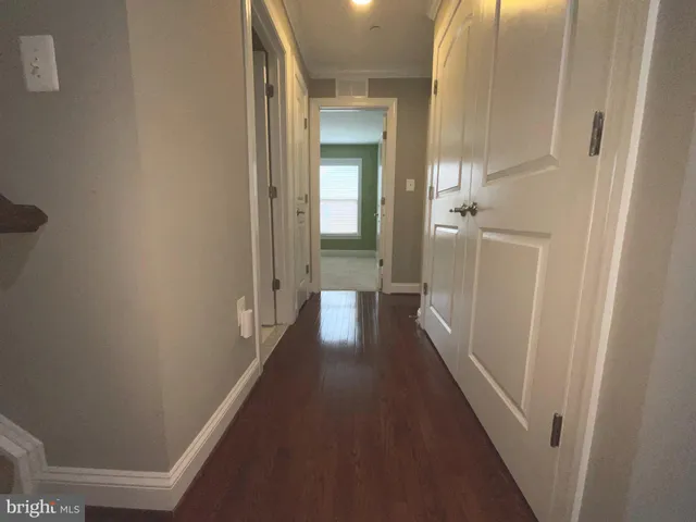 a view of a hallway with a wooden floors