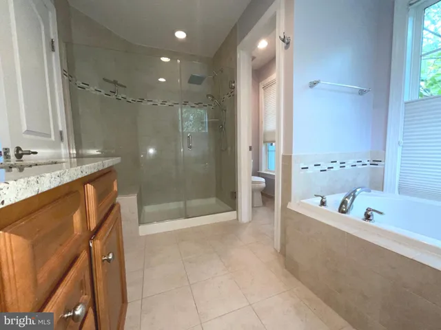 a bathroom with a bathtub a shower a sink and a mirror